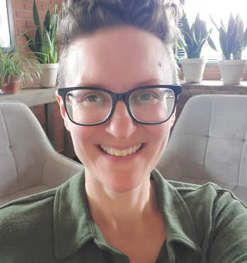 Provider Diana Calvo, wearing a green blouse with glasses, smiling.